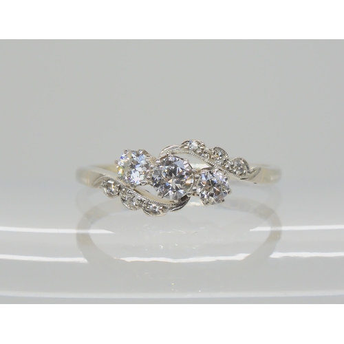 526 - AN 18CT WHITE GOLD AND PLATINUM THREE STONE DIAMOND RING