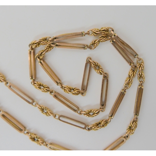 527 - A 9CT GOLD PIERCED BATON AND FANCY LINK GUARD CHAIN