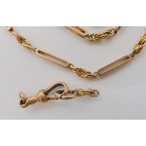 527 - A 9CT GOLD PIERCED BATON AND FANCY LINK GUARD CHAIN