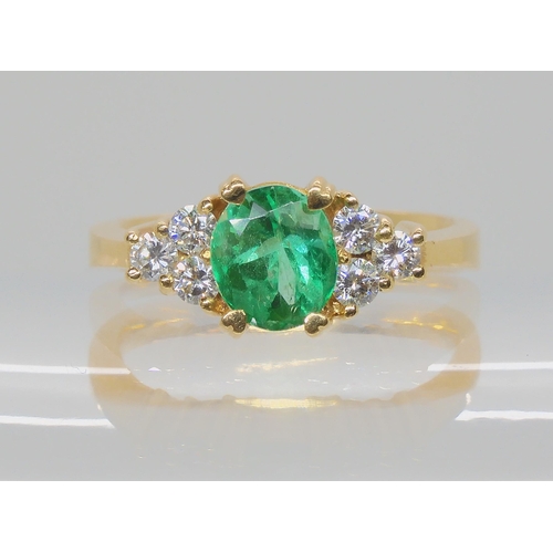 528 - AN EMERALD AND DIAMOND RING