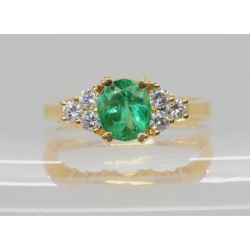 528 - AN EMERALD AND DIAMOND RING