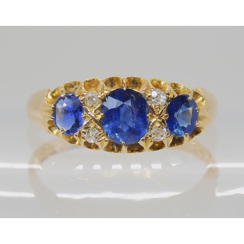 538 - A SAPPHIRE AND DIAMOND THREE STONE RING