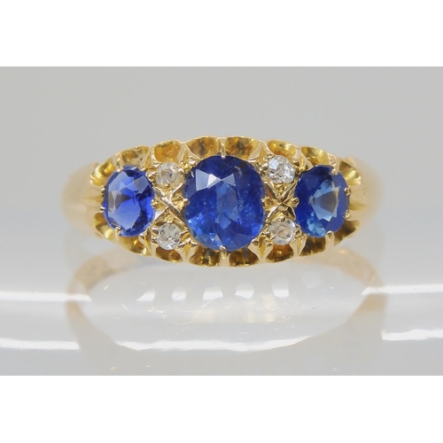 538 - A SAPPHIRE AND DIAMOND THREE STONE RING