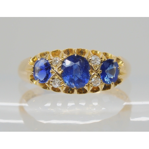 538 - A SAPPHIRE AND DIAMOND THREE STONE RING