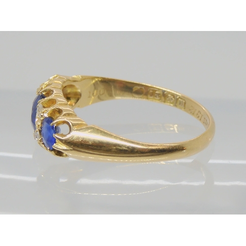 538 - A SAPPHIRE AND DIAMOND THREE STONE RING