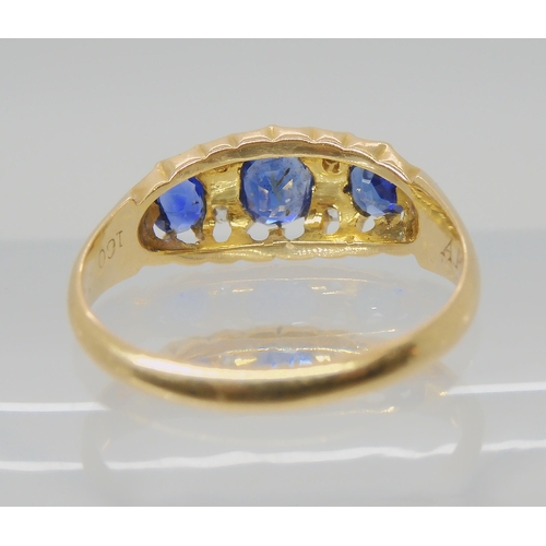 538 - A SAPPHIRE AND DIAMOND THREE STONE RING