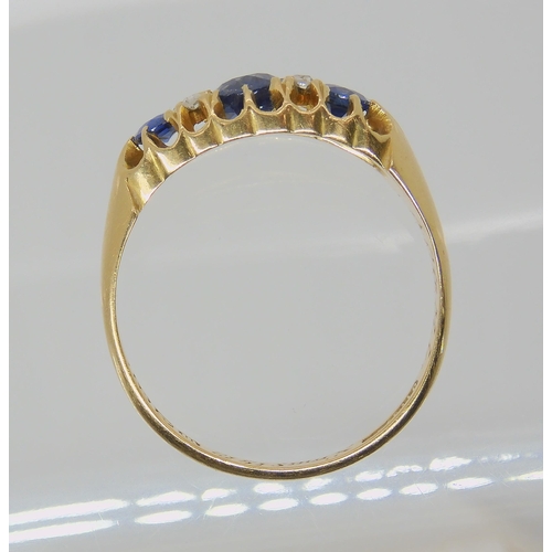 538 - A SAPPHIRE AND DIAMOND THREE STONE RING