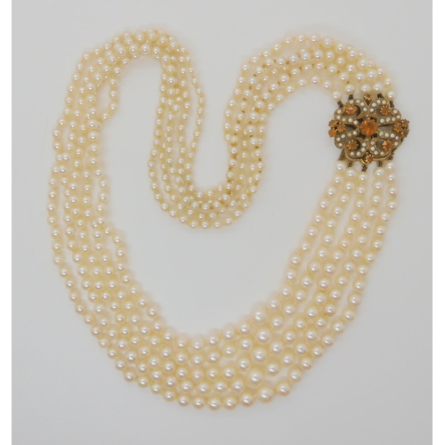 546 - A FIVE STRAND PEARL NECKLACE WITH A 9CT CITRINE AND PEARL CLASP