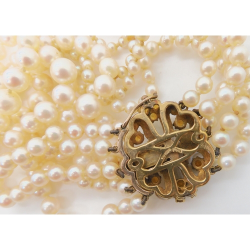 546 - A FIVE STRAND PEARL NECKLACE WITH A 9CT CITRINE AND PEARL CLASP