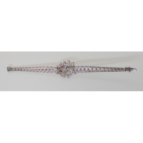 555 - AN 18CT WHITE GOLD RUBY AND DIAMOND BRACELET