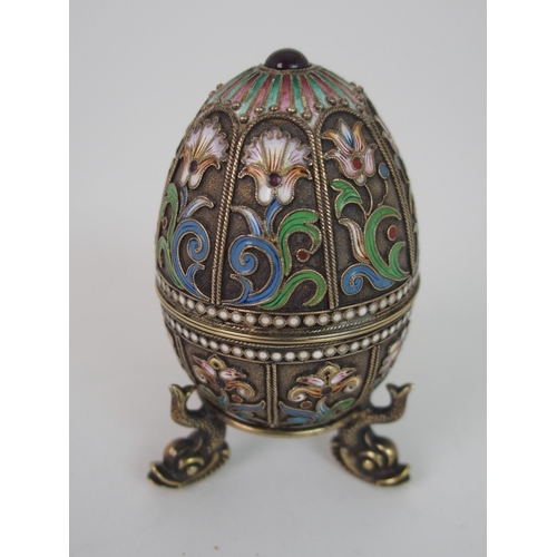 708 - A RUSSIAN SILVER GILT AND ENAMEL EGG