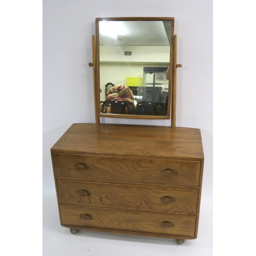 112 - AN ERCOL GOLDEN DAWN DRESSING CHEST WITH SWIVEL MIRROR OVER THREE GRADUATING DRAWERS