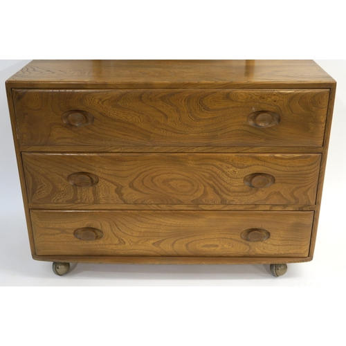 112 - AN ERCOL GOLDEN DAWN DRESSING CHEST WITH SWIVEL MIRROR OVER THREE GRADUATING DRAWERS