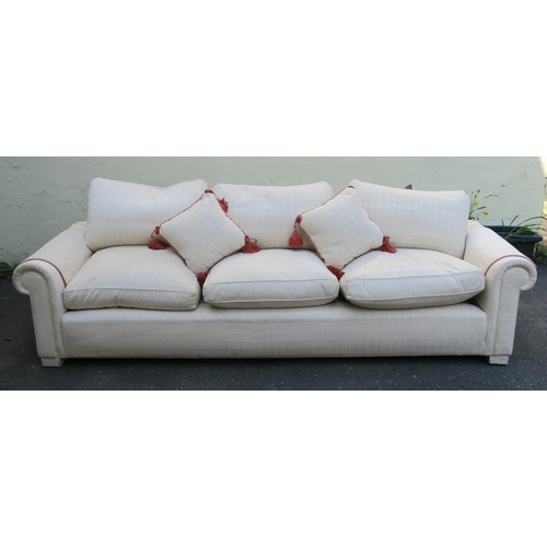 126 - A LARGE CREAM HUMPBACK SOFA