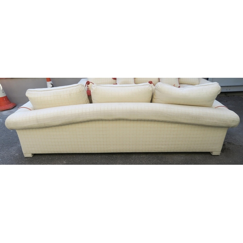 126 - A LARGE CREAM HUMPBACK SOFA