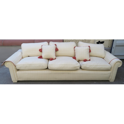 127 - A LARGE CREAM HUMPBACK SOFA