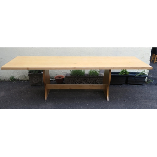 129 - A LARGE BESPOKE DINING TABLE WITH WAVY EDGE SUPPORTS AND SINGLE STRETCHER