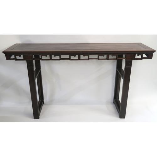 2 - A CHINESE HARDWOOD ALTER TABLE with carved and pierced key pattern frieze set on squared legs inset ... 