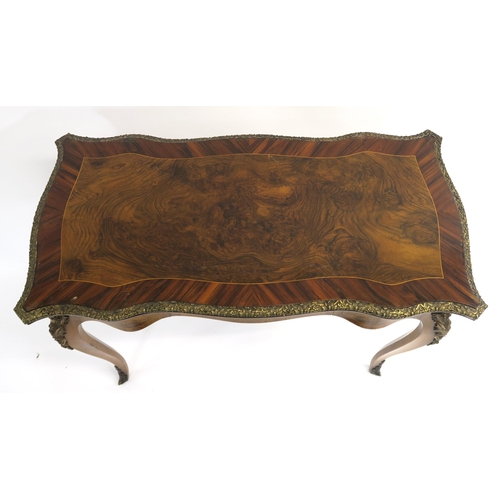 3 - A LOUIS XV STYLE WALNUT  ROSEWOOD AND FRUITWOOD WRITING DESK the shaped top with cast brass foliate ... 