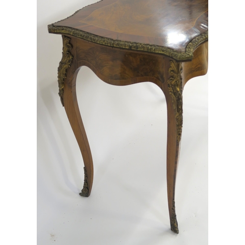 3 - A LOUIS XV STYLE WALNUT  ROSEWOOD AND FRUITWOOD WRITING DESK the shaped top with cast brass foliate ... 