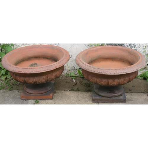 30 - A PAIR OF DOULTON & CO LIMITED LAMBETH STONEWARE GARDEN URNS AND STANDS