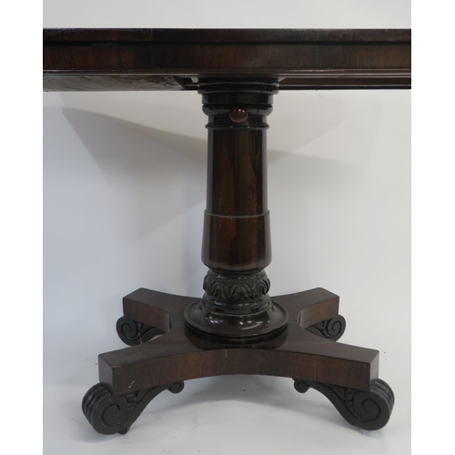 6 - A VICTORIAN ROSEWOOD LIBRARY TABLE the rectangular top set with twin hinged reading slopes and on gu... 