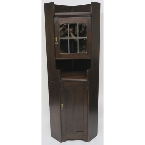 71 - A LIBERTY & CO OAK CORNER CABINET OF ARCHITECTURAL FORM