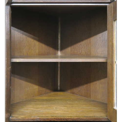 71 - A LIBERTY & CO OAK CORNER CABINET OF ARCHITECTURAL FORM