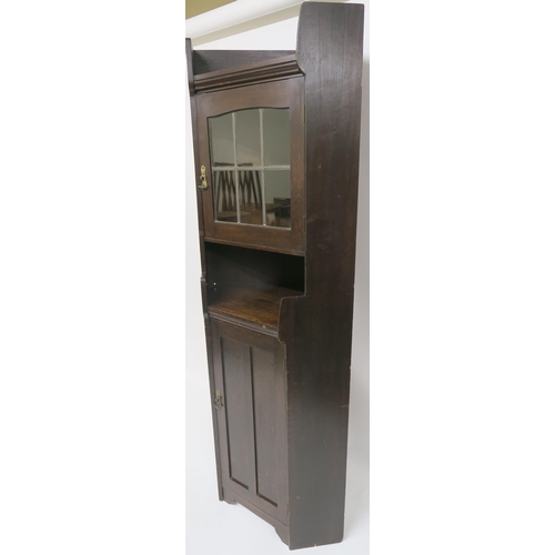 71 - A LIBERTY & CO OAK CORNER CABINET OF ARCHITECTURAL FORM