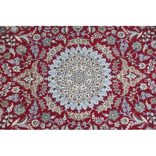82 - A RED GROUND NAIN RUG WITH CREAM CENTRAL MEDALLION  SPANDRELS AND BORDERS