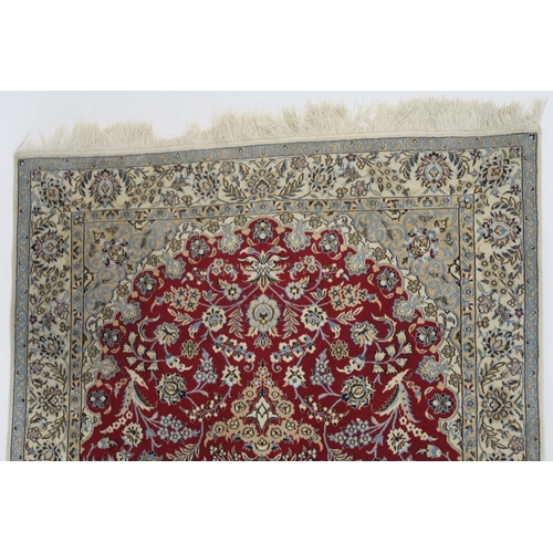 82 - A RED GROUND NAIN RUG WITH CREAM CENTRAL MEDALLION  SPANDRELS AND BORDERS
