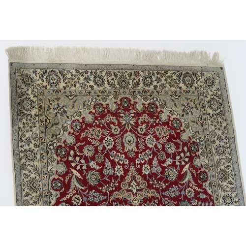 82 - A RED GROUND NAIN RUG WITH CREAM CENTRAL MEDALLION  SPANDRELS AND BORDERS