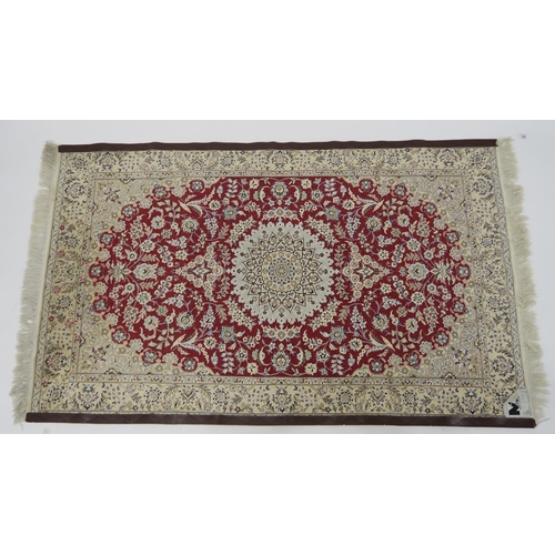 82 - A RED GROUND NAIN RUG WITH CREAM CENTRAL MEDALLION  SPANDRELS AND BORDERS