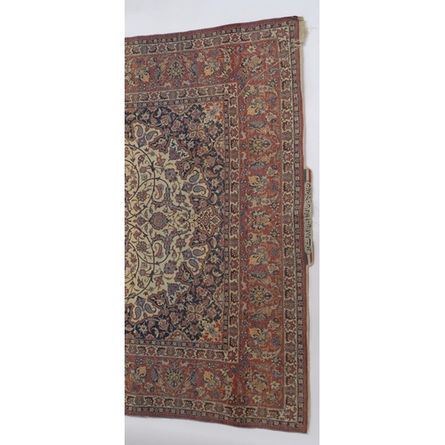 85 - A SIGNED CREAM GROUND ISFAHAN RUG WITH CENTRAL MEDALLION
