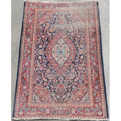 93 - A BLUE GROUND EASTERN RUG WITH CENTRAL MEDALLION