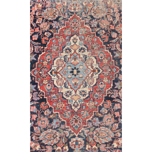 93 - A BLUE GROUND EASTERN RUG WITH CENTRAL MEDALLION