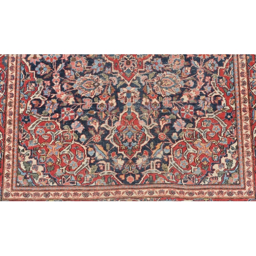 93 - A BLUE GROUND EASTERN RUG WITH CENTRAL MEDALLION