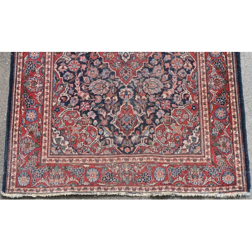 93 - A BLUE GROUND EASTERN RUG WITH CENTRAL MEDALLION