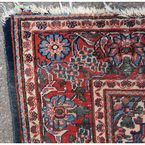 93 - A BLUE GROUND EASTERN RUG WITH CENTRAL MEDALLION