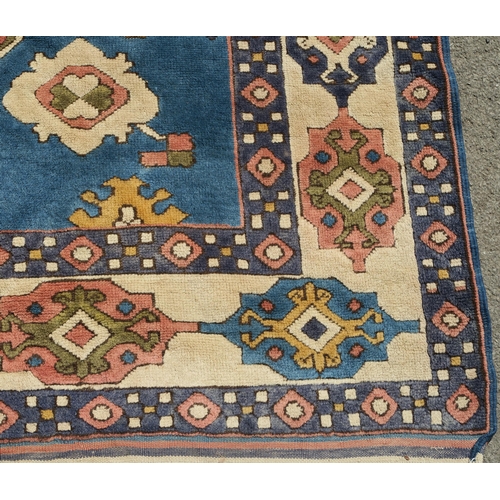 96 - A DARK PINK GROUND EASTERN RUG WITH BLUE SPANDRELS