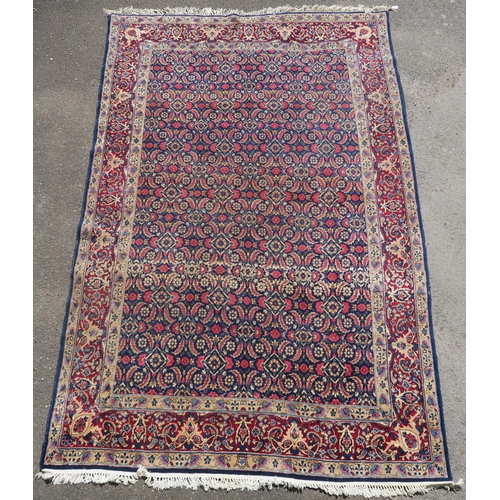 97 - A BLUE GROUND EASTERN RUG WITH ALLOVER DESIGN