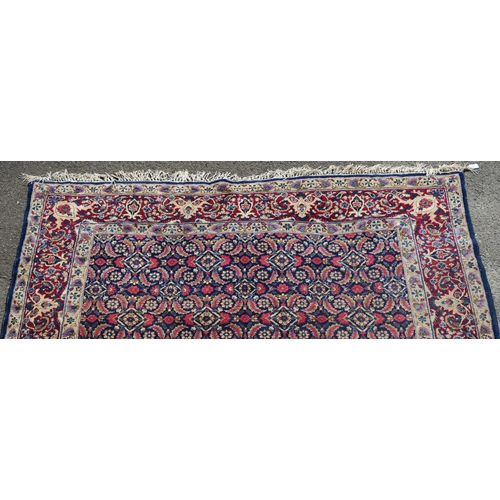 97 - A BLUE GROUND EASTERN RUG WITH ALLOVER DESIGN