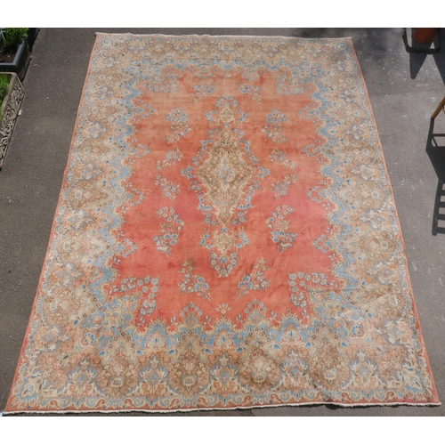 98 - A PINK GROUND RUG WITH CENTRAL MEDALLION