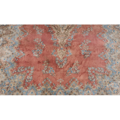 98 - A PINK GROUND RUG WITH CENTRAL MEDALLION