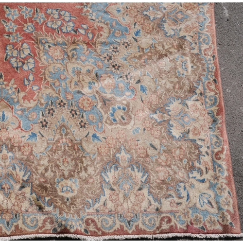 98 - A PINK GROUND RUG WITH CENTRAL MEDALLION