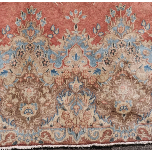 98 - A PINK GROUND RUG WITH CENTRAL MEDALLION