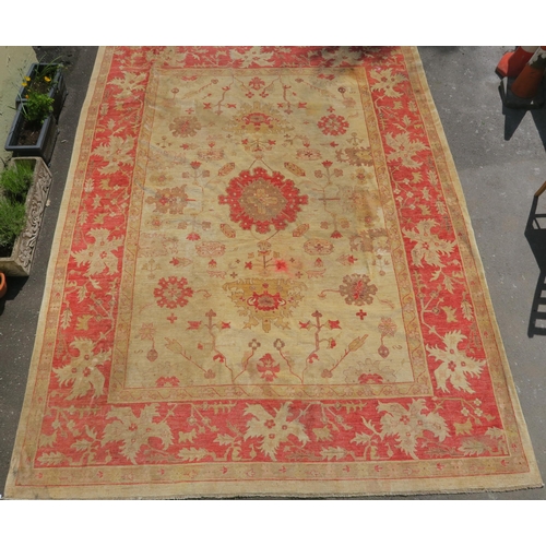 98A - A BEIGE GROUND ZIEGLER RUG WITH CENTRAL MEDALLION