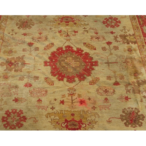 98A - A BEIGE GROUND ZIEGLER RUG WITH CENTRAL MEDALLION