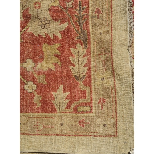 98A - A BEIGE GROUND ZIEGLER RUG WITH CENTRAL MEDALLION