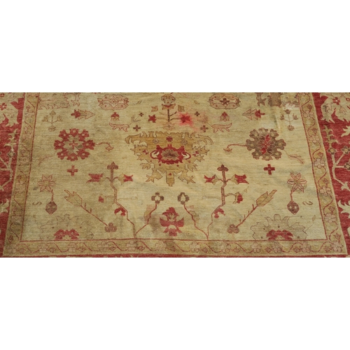 98A - A BEIGE GROUND ZIEGLER RUG WITH CENTRAL MEDALLION